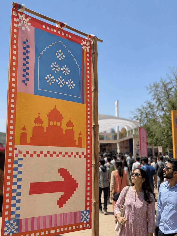 Festival wayfinding banner pointing the way through the grounds